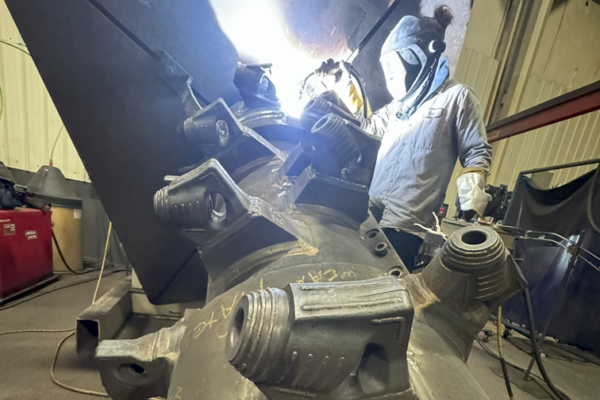 Worker Welding a Drum
